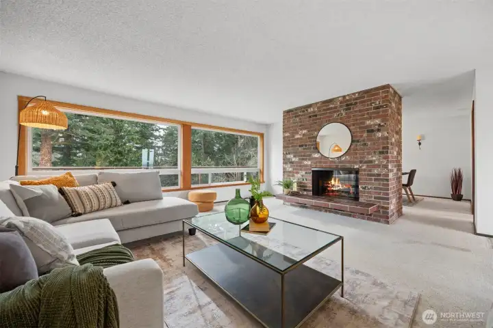 The living room has large widows that bring in the southern sunlight and take in the filtered views.