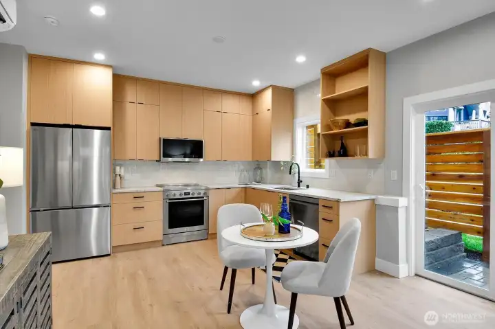 Great natural light with large windows and sliding glass door to fenced patio area