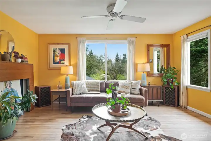 Oak hardwood floors and large windows looking out at greenery at every vista.