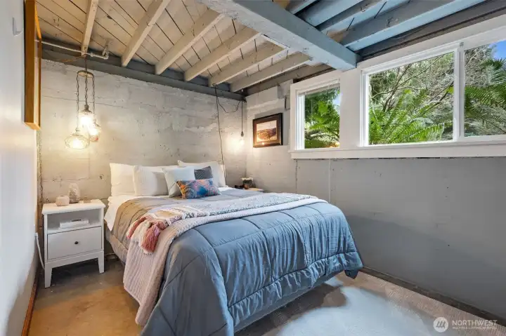 The primary looks out onto the view of ferns and greenery.