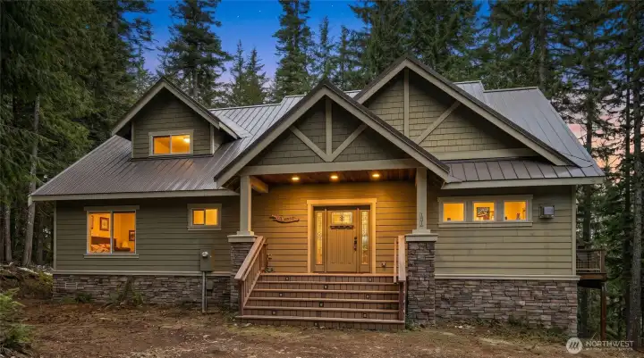 Classic Craftsman charm meets mountain serenity—inviting front porch, rich wood accents, and timeless architectural details set the tone for this peaceful retreat.