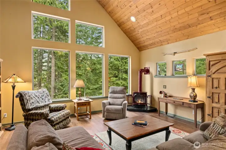 Expansive windows frame tranquil forest views, bringing the outdoors in and creating a true mountain-lodge feel.