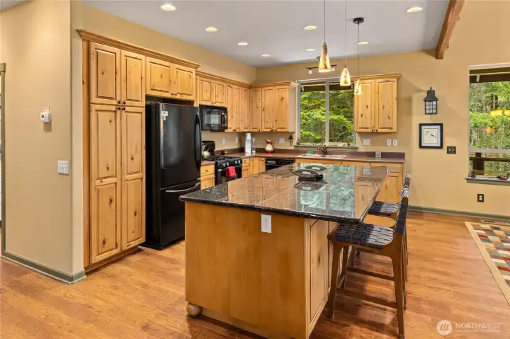 Beautifully appointed kitchen with granite countertops, custom cabinetry, and a spacious island—perfect for gathering and entertaining.