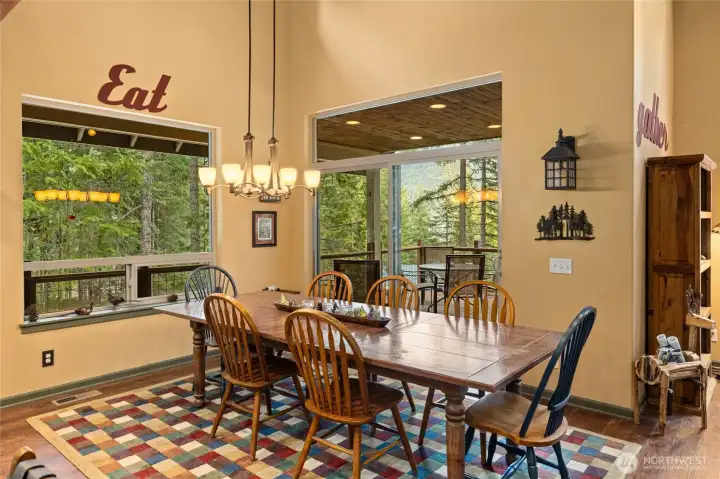 Dining space surrounded by nature, with easy access to the deck.
