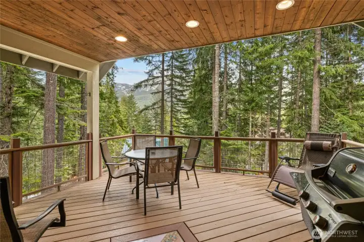 Expansive covered deck just off the dining area—perfect for year-round enjoyment, with beautiful mountain views and space to relax or entertain.