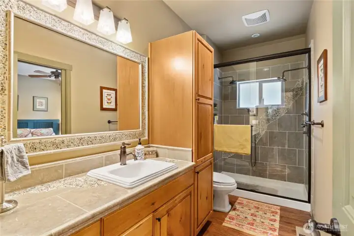 Convenient main floor bath featuring a walk-in shower and clean, functional design—ideal for guests and everyday ease.