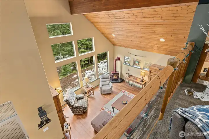 Bright and open loft area that overlooks the main living space, enhancing the home’s sense of flow and spaciousness while providing a flexible bonus area.