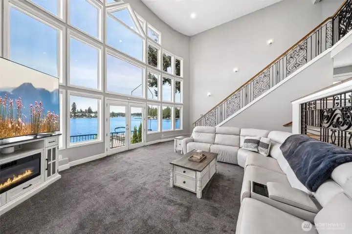 Wall of windows floods w/natural light, showcasing stunning lake views.