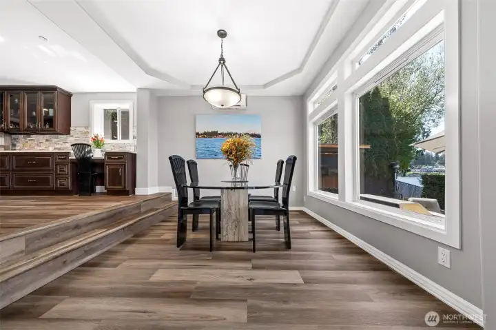 Dining room with LVP flooring enjoys beautiful water views and sits just off the kitchen, creating a bright and inviting space.