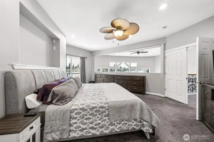 Another view of the primary suite that has an open view of family room windows overlooking the lake. Does have a automatic shade that is retractable for privacy.