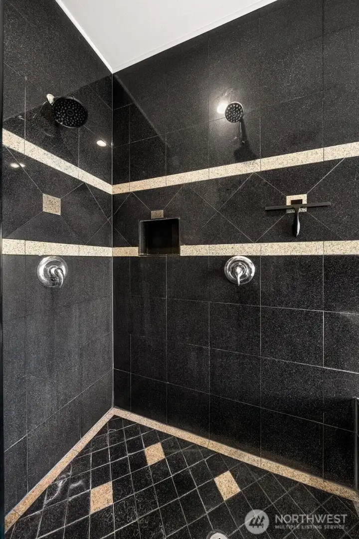 Primary suite with full tile walk-in shower & double shower head.