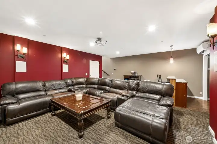 Main floor theatre room with built in bar.