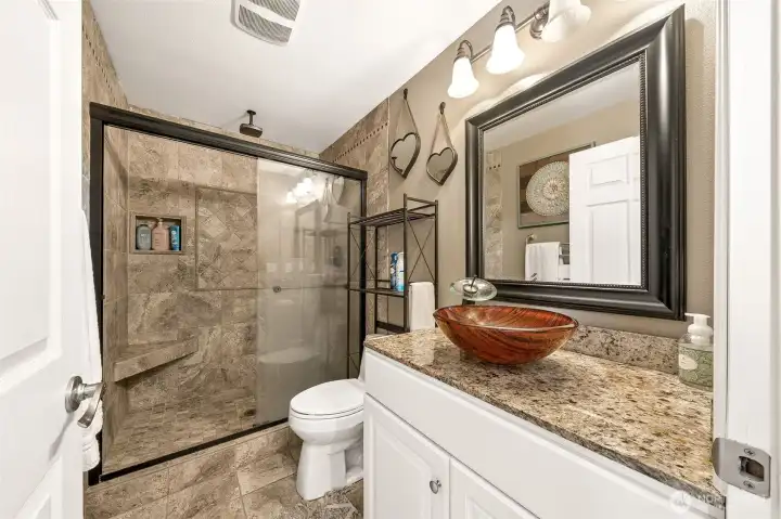 3/4 bathroom upstairs with complete tile surround, custom sink & tile floors.