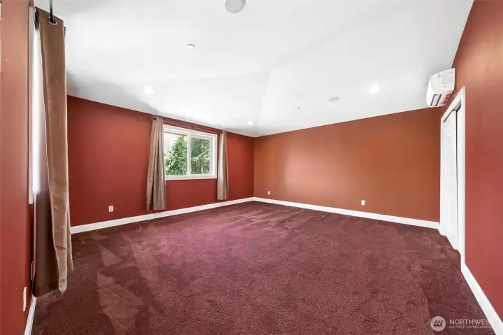 One of two bedrooms upstairs for the potential ADU. Vaulted ceilings, white trim + mini split to keep it the perfect temperature.