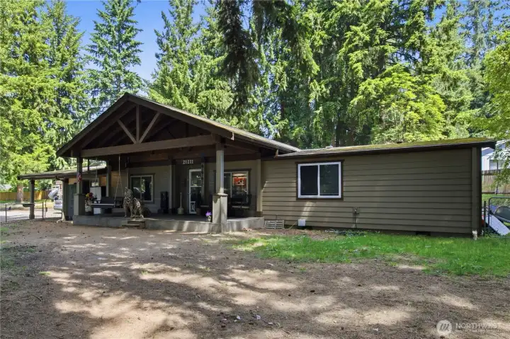 Large covered front porch welcomes you to the main home