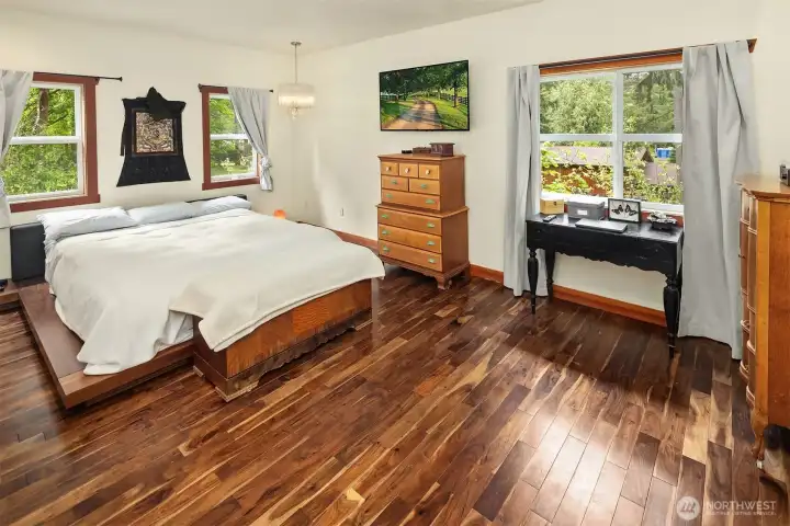 Primary Bedroom with Acacia Hardwood floors (upper level is all Acacia Hardwoods) and lots of windows letting in natural light. Completely remodeled primary bathroom – tile flooring, granite his and her vanity, large, tiled shower. (2021)