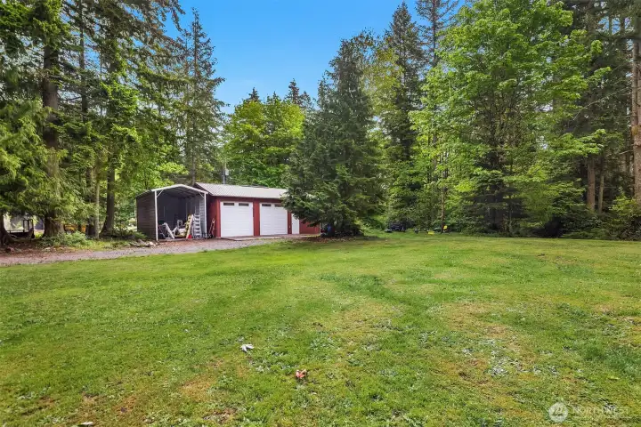 Huge Shop with 5+ parking spaces. Room for boats, RV and all your toys!  Dual 23-foot carports with RV hookup