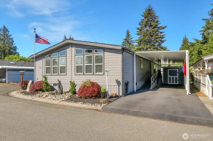 Two car carport with large storage shed