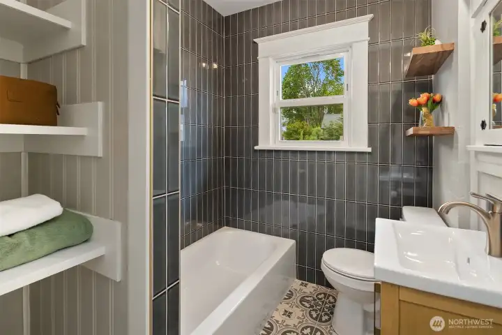 Designer bathroom with storage, this space is cute and has great light