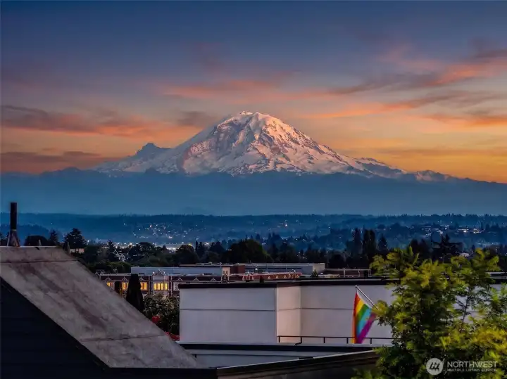 Rooftop terrace view toward Mount Rainier and the surrounding cityscape.
