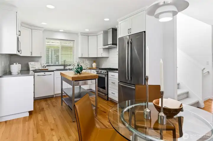 Updated kitchen and dining area with hardwood floors and modern finishes.