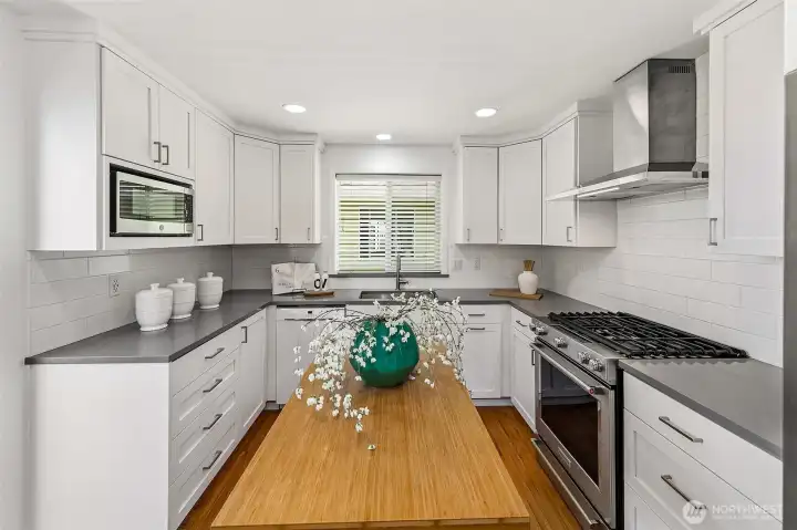Updated kitchen with island, stainless appliances and abundant cabinetry.