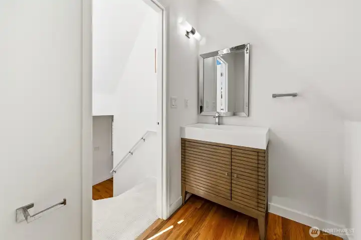 Powder room tucked between the living level and rooftop terrace access.