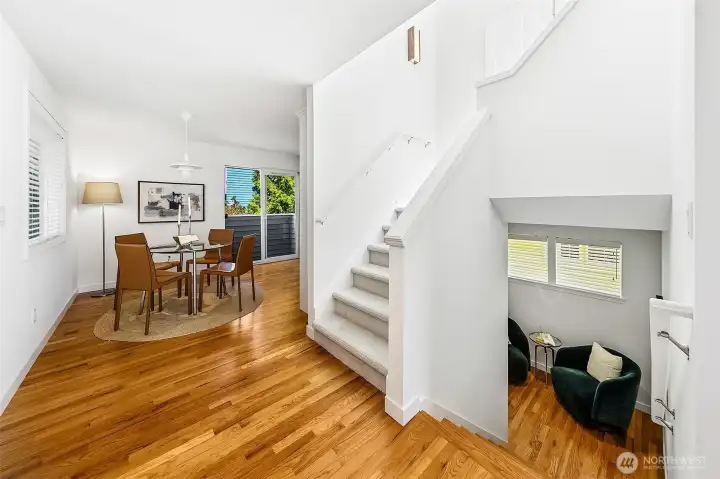 Oak hardwoods lead to a landing flex space that softens the transition from living to the quieter bedroom level.