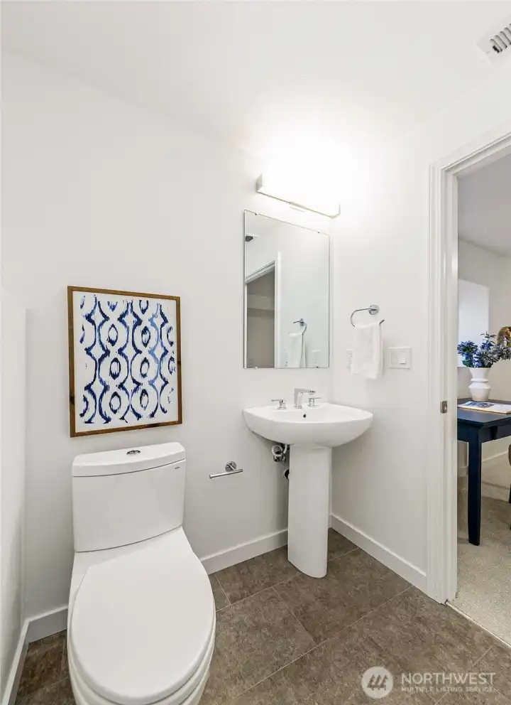 Internal half bath serves the third bedroom/office, with roughed-in shower drain and nearby water heater for possible future expansion.