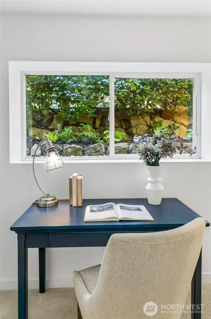 Quiet lower-level work space with garden outlook.