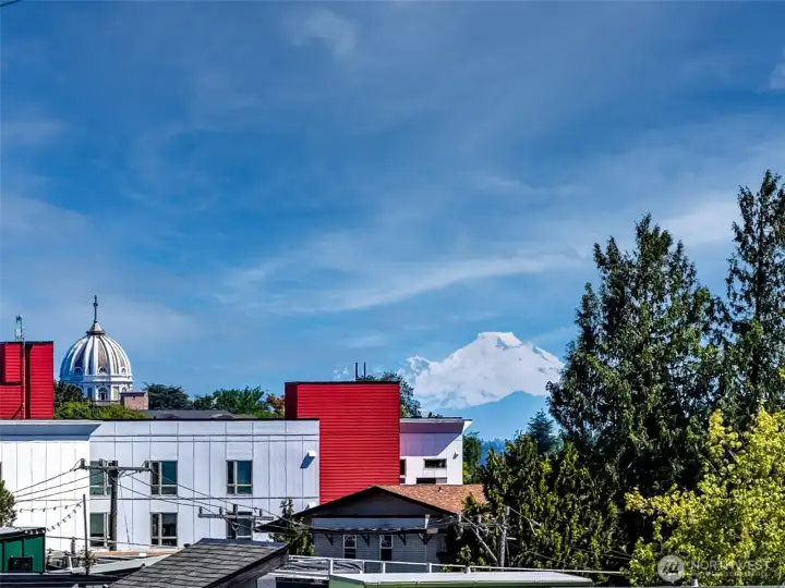 North-facing rooftop outlook includes a rare glimpse of Mount Baker beyond the city.