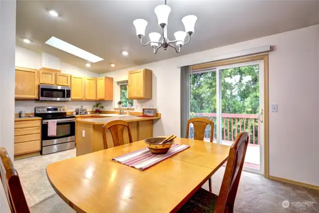 Kitchen, dining, & slider to the upper deck.  Kitchen skylight provides additional natural light.
