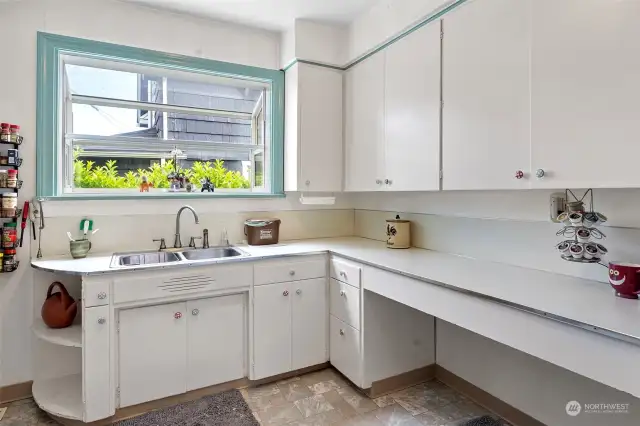 A lot of counter top space with a garden window above the sink.