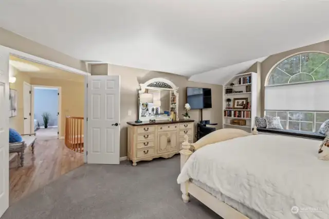 A view from the primary bedroom with french doors to the hallway and staircase.