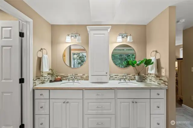 Another view of the elegant double vanity in the primary bath with no-edge sinks and plenty of storage.