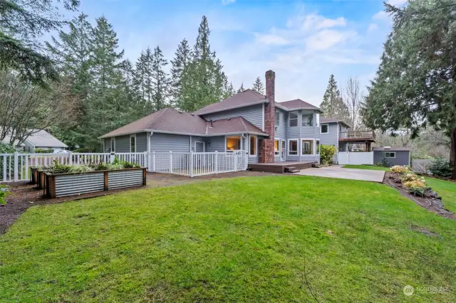 The back yard is amazing with a dog run, raised beds for growing plants/flowers, a large patio off of the trex deck, and so much more. A wedding was recently held in this yard.