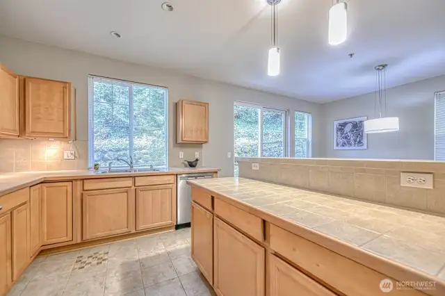 Framed by greenery, the kitchen offers a peaceful view of the treed hillside—an inspiring backdrop.