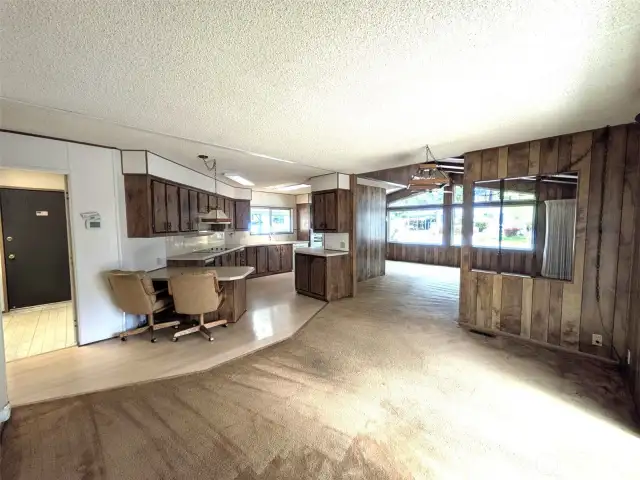 Good view of the layout. Far end living room with huge windows. Kitchen to the left and family room nearest.