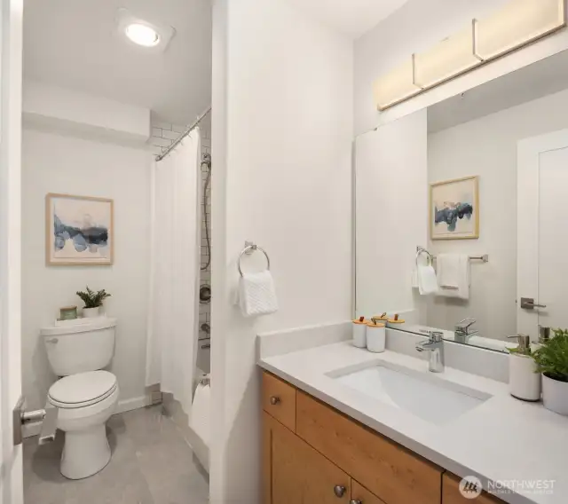 Guest bathroom with tub. Has been remodeled