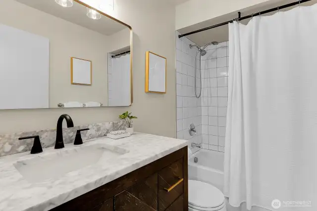 Remodeled bathroom with marble accents.