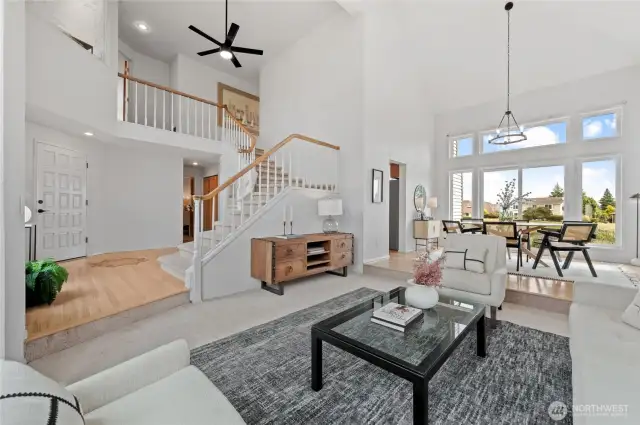 View from the Living Room to the entry on the left, Dining Room on the right. Three bedrooms are located upstairs.