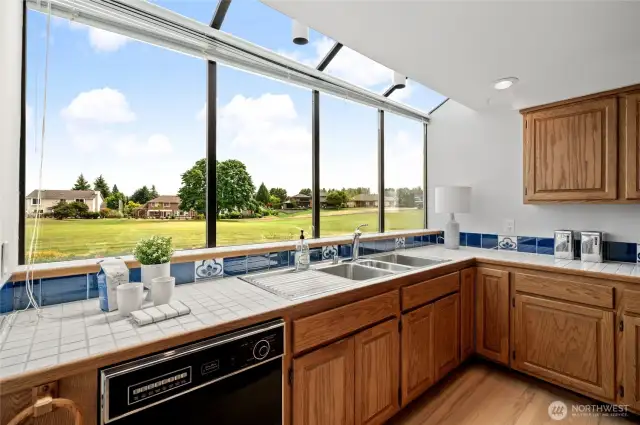 Natural light floods the kitchen and provides panoramic views of the golf course and mountain!
