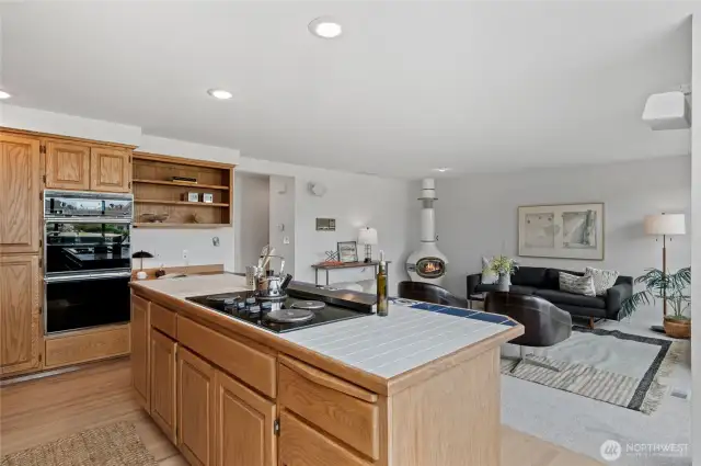 The Kitchen extends into a welcoming Family Room, where a custom wood-burning stove creates the perfect ambiance for quiet evenings or lively conversation.