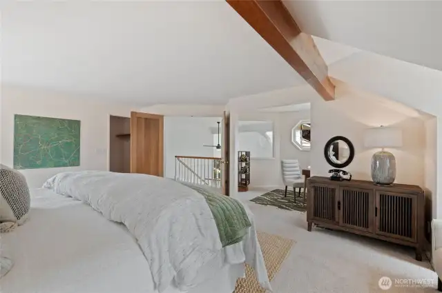 The Primary Bedroom offers a grand double-door entry, a private office nook with lofted views of the Living Room and Entry, a spacious walk-in closet with a convenient laundry chute, direct access to a secluded outdoor patio, and a luxurious ensuite bath.