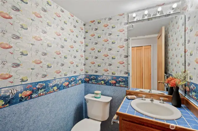 Back on the main level, just past the entry, is a cozy half-bath setting for your use, and the convenience of your guests.