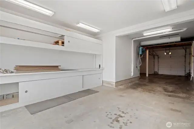 The back side of the garage has a large workbench area and a slider to the back patio.
