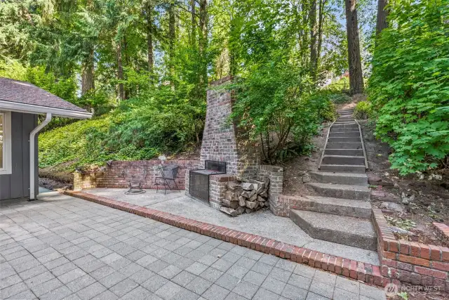 Exterior Wood Fireplace and Trails Throughout the Backyard