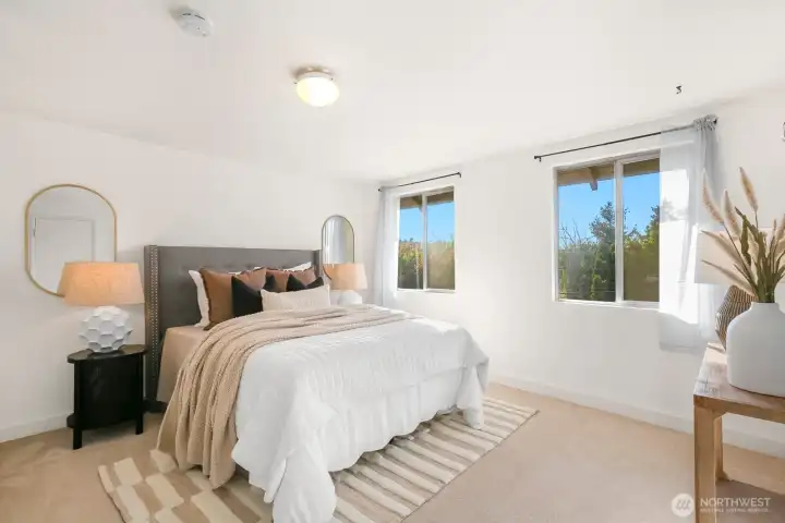 The primary bedroom upstairs is west facing and at the end of the hallway. This room accommodates large furniture and is the perfect spot to catch the sunset skies.