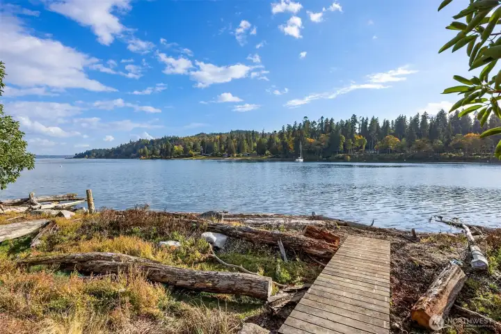 A solid wood bridge leads to the shore on the west side of the property.