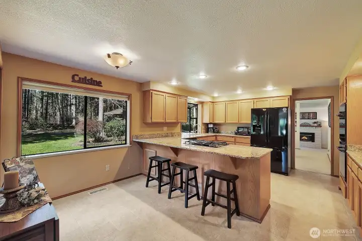 Gourmet kitchen with breakfast bar and space for breakfast nook